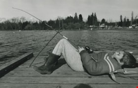 Boy fishing on a lake, ca.1983 thumbnail