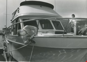 Man and a woman working on their boat, ca.1983 thumbnail