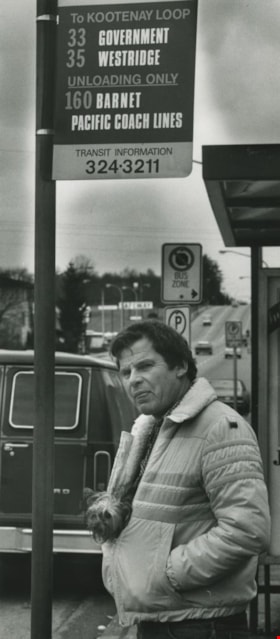 Man and a dog standing by a bus stop, ca.1983 thumbnail