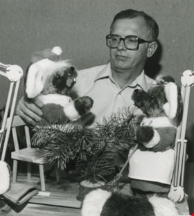 Man playing with stuffed animals, ca.1983 thumbnail