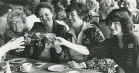 People toasting with champagne, ca.1983 thumbnail