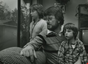 Kristen, Dave and Ambrose Hunt looking out their window, ca.1983 thumbnail