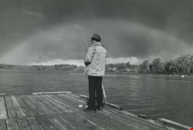 A man fishing on a dock, ca.1983 thumbnail