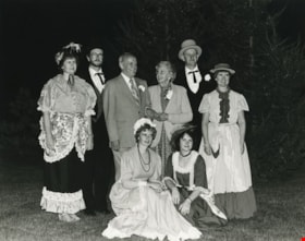 An elderly couple, joined by people dressed up in old fashioned clothing, ca.1983 thumbnail