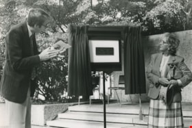 A man and a woman unveiling a plaque, ca.1983 thumbnail