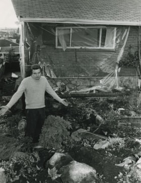 Man outside by a destroyed backyard, [1982] thumbnail