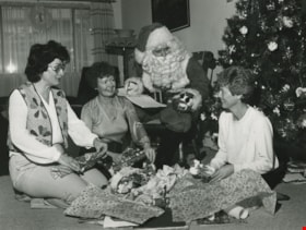 Volunteers wrapping presents with Santa, December 1982 thumbnail