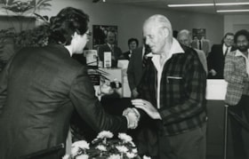 Two men shaking hands, ca.1982 thumbnail