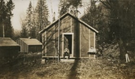 Man sitting on cabin steps, 1926 thumbnail