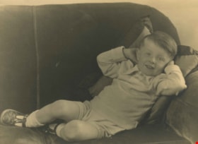 Boy reclining on a chesterfield, [1912] thumbnail