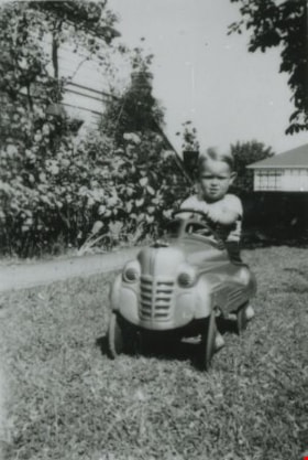 Don Cary in a toy pedal car, [1945] (date of original), copied 1991 thumbnail