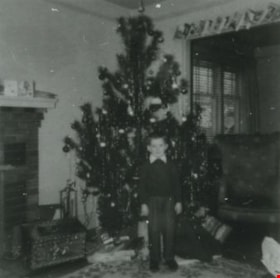 Robert Matheson in front of a Christmas tree, December 1952 (date of original), copied 1991 thumbnail