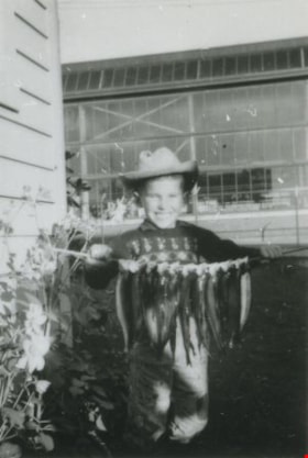 Michael Loynes holding a line of fish, October 1957 (date of original), copied 1991 thumbnail