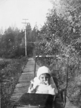 Child on Douglas Road sidewalk, [1915 or 1916] (date of original), copied 1991 thumbnail