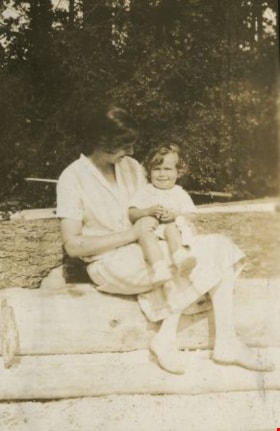 Woman holding Robert Peers at the beach, [1928] thumbnail