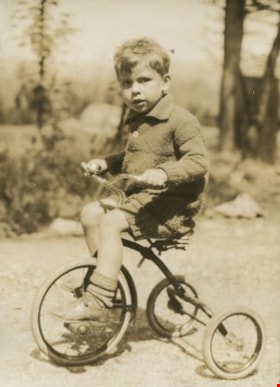 Robert riding a tricycle, [1930] thumbnail