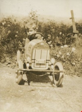 Robert on a toy tractor, [1930] thumbnail
