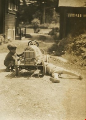 Robert and his friend fixing a toy tractor, [1930] thumbnail