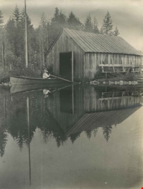Kitty Hill paddling into Claude Hill's boathouse, 1910 thumbnail