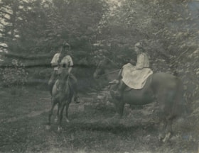 Kitty Hill and a friend riding horses, 1910 thumbnail