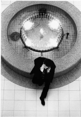 Man sitting by fountain, December 17, 1995 thumbnail
