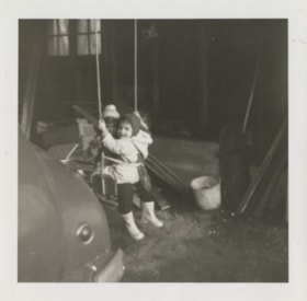 Rhonda and Sherrie playing on their swing, 1957 thumbnail