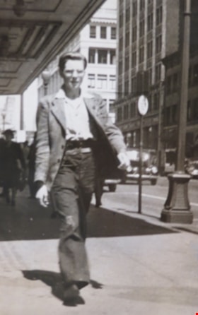 Roy Brainerd walking along Granville Street in Vancouver, [1945 or 1946]. Item no. 549-016 thumbnail