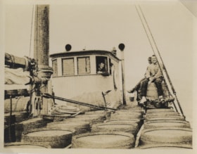 Three unidentified men on a boat, [between 1918 and 1925] thumbnail