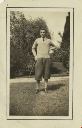Unidentifed man holding a golf club, [between 1940 and 1960] thumbnail