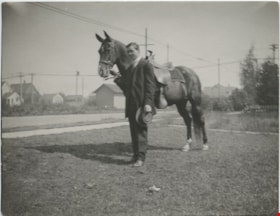 Young man standing beside a horse, [190-] thumbnail