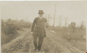 Young man walking along country road, [190-] thumbnail