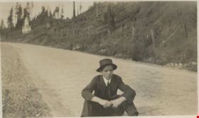 Young man sitting on road, [190-] thumbnail