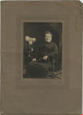 Woman in a chair, [189-] thumbnail