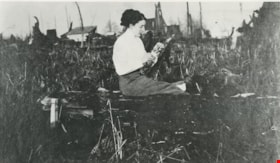 Maude Hill seated on a felled log, [190-?] (date of original), copied 1977 thumbnail