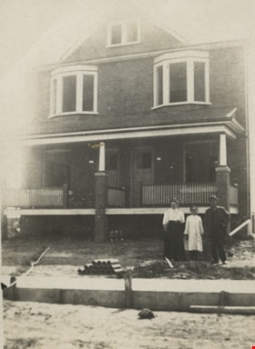 Family in front of their house, [190-] thumbnail