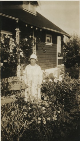 Woman standing in a garden, [between 1912 and 1925] thumbnail