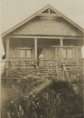 Woman standing on the porch, [between 1912 and 1925] thumbnail