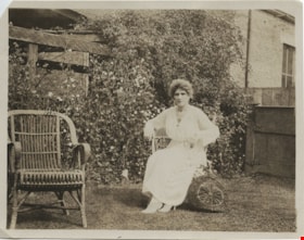 Woman in a wicker chair, [191-] thumbnail