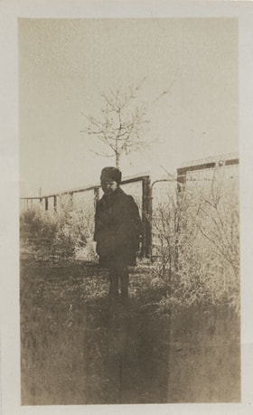 Boy in front of a wire fence, [1915] thumbnail