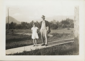Girl and man by street car tracks, [193-] thumbnail