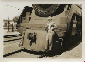 Man standing on footboards of train, [between 1930 and 1949] thumbnail