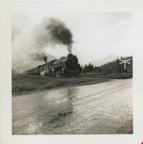 Train travelling towards a railway crossing, [between 1930 and 1949] thumbnail