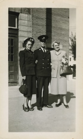 Fire Official with two women, [194-?] thumbnail