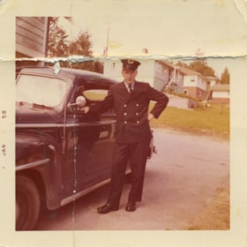 Fireman standing next to his car, January 1958 thumbnail