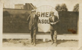 Two men in front of Shell Gasoline logo, [193-] thumbnail