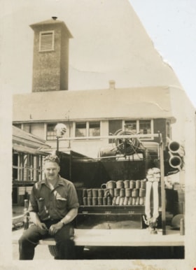 Fireman sitting on the tailgate of a fire truck, [1939] thumbnail