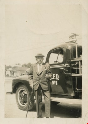Man standing by fire truck, [194-?] thumbnail