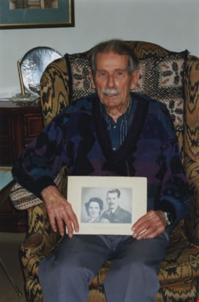 Gordon Davis holding a photograph of himself and Anne Williams Davis, 2002 thumbnail