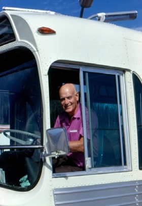 Archy MacLeod in driver's seat of bus, 1973 thumbnail