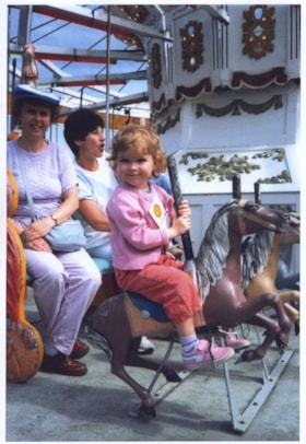 Elinor and Sarah Knudson riding on C.W. Parker no. 119 carousel, August 23, 1986 thumbnail